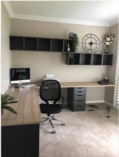 an office with a desk and shelves on the wall