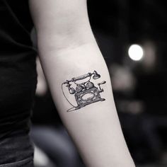 a woman's arm with a small tattoo of an old fashioned phone on it