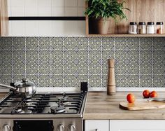 a stove top oven sitting inside of a kitchen next to a cutting board and pot