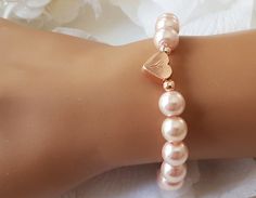 This personalized flower girl bracelet is made with blush pink color little glass pearls (8 mm) and rose gold plated hand stamped heart charm. This stretch pearl bracelet is perfect gift for your flower girls, jr bridesmaids or bridesmaids. Please visit my store to see the other wedding jewelry https://www.etsy.com/shop/asteriasbridal Elegant Personalized Rose Gold Beaded Bracelets, Elegant Personalized Rose Gold Beaded Bracelet, Elegant Rose Gold Heart Beaded Bracelets, Adjustable Rose Gold Charm Bracelet For Wedding, Personalized Rose Gold Bracelets For Wedding, Elegant Beaded Bracelet With Heart Charm For Wedding, Elegant Pink Beaded Bracelet With Heart Charm, Elegant Wedding Beaded Bracelet With Heart Charm, Personalized Rose Gold Wedding Bracelets