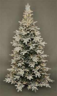 a white christmas tree with snow on it