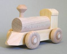 a small wooden toy train on a gray background