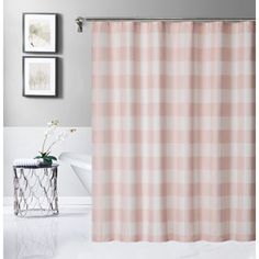 a pink and white checkered shower curtain in a bathroom with two pictures on the wall