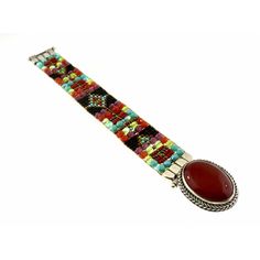 Chili Rose Mini Aragon Black Fortuna Bracelet Carnelian Stone lays in the middle of the Bracelet when on the wrist -19mm wide -Hand Beaded on a Loom -Red, Turquoise, Jet and Olive colored Beads -Sterling Silver -Interlocking Clasp Closure -Made in Santa Fe, New Mexico -Length: 7in. -*Length can be custom made, just let us know at checkout! Anything over 8in. is an additional charge* Red Gemstone Beaded Bracelet Bohemian Style, Red Bohemian Beaded Gemstone Bracelet, Bohemian Multicolor Bracelet Strap Jewelry, Unique Red Gemstone Bracelets, Unique Red Gemstone Bracelet, Southwestern Style Adjustable Red Bracelets, Adjustable Red Southwestern Bracelets, Red Band Bracelet As Gift, Red Band Bracelet For Gift