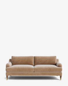 a tan couch against a white wall with no one on it's back legs