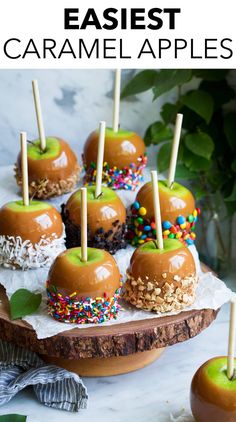 caramel apples with sprinkles and nuts on a wooden platter