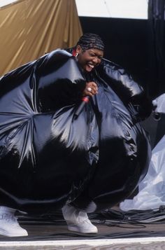 a woman in a large black plastic bag