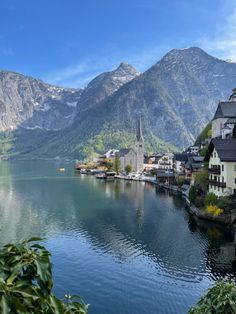 a lake surrounded by mountains and houses