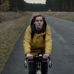 a man riding a bike down a road