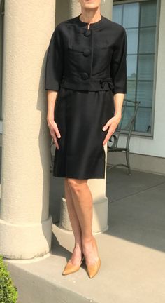 This is a vintage, black, suit from the 1960s. This 2 piece, jacket and skirt suit, or set, is perfectly clean, and in pristine condition....and I do not use the word pristine often, when describing vintage clothing. This modern, 1960s, black, suit is custom made for sure, and both pieces are fully lined in a clean, black, fabric. I believe the gorgeous fabric on this vintage suit is either a silk blend, or a rayon fabric, that is meant to look like silk. Either way, the black fabric looks and f Formal Black Fitted Skirt Suit, Black Fitted Skirt Suit For Formal Occasions, Classic Black Skirt Suit For Work, Elegant Black Skirt Suit For Formal Occasions, Classic Black Skirt Suit For Office, Classic Black Skirt Suit For The Office, Classic Black Business Skirt Suit, Classic Black Skirt Suit For Business, Elegant Black Skirt Suit With Notch Lapel