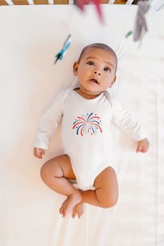 Celebrate the Fourth of July in style with this adorable long sleeve baby bodysuit! Perfect for your little one’s first Independence Day, this bodysuit combines comfort with festive flair. Dress your little one in this charming Fourth of July long sleeve baby bodysuit and let them shine as brightly as the fireworks in the night sky! The infant long sleeve bodysuit does just that. Solid colors are 100% cotton. Other colors will include polyester. Either way, the fabric will be smooth and soft aga July Baby, Flair Dress, White Onesie, The Fourth Of July, Long Sleeve Bodysuit, Baby Photos, Fourth Of July, Baby Bodysuit, Night Sky