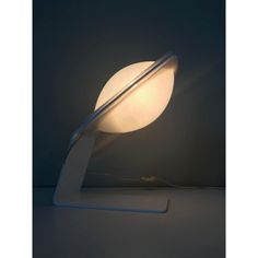 a lamp that is sitting on top of a table with a light in front of it