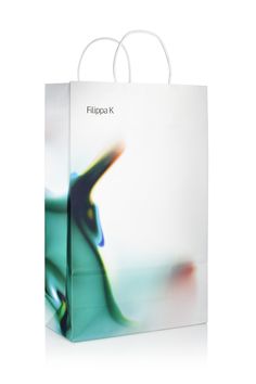 a white shopping bag with a blurry image on the front and back of it