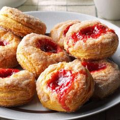 a white plate topped with pastries covered in jelly