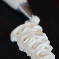 a toothbrush is being used to brush the brizzle on top of some noodles