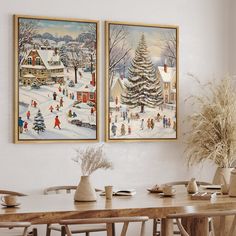 two paintings hang on the wall above a dining room table