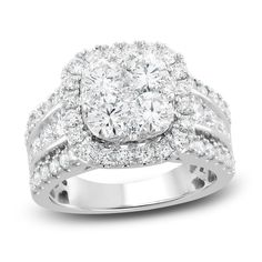 a white gold diamond ring with two rows of diamonds on the band and an oval shaped center