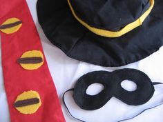 a hat, tie and mask are sitting on a table