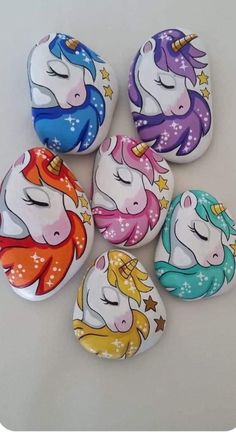 six painted rocks with unicorns on them