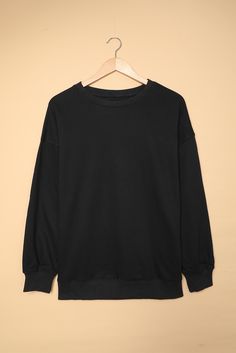 Black Oversized Solid Drop Shoulder Sweatshirt Oversized Black T-shirt With Ribbed Cuffs, Oversized Plain T-shirt For Fall, Oversized Black Plain Top, Basic Oversized Plain Sweater, Oversized Basic Plain Sweater, Oversized Black Tops For Fall, Oversized Black Top For Fall, Black T-shirt With Ribbed Cuffs For Fall, Oversized Long Sleeve Plain T-shirt