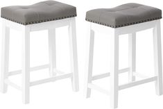 two white stools with grey cushions on each side and one in the same color