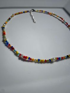 This trendy and bright beaded necklace has classy pearls scattered throughout the colorful beads. It is 16" with a 2" extension chain. Trendy Necklace With Spacer Beads For Summer, Summer Party Beaded Necklaces With Round Beads, Summer Party Beaded Necklace With Beaded Chain, Summer Party Beaded Necklaces, Summer Party Beaded Necklace, Multicolor Pearl Beaded Necklaces For Parties, Trendy Pearl Beaded Necklaces With Tiny Beads, Trendy Pearl Beaded Necklace With Tiny Beads, Multicolor Beads For Summer Parties