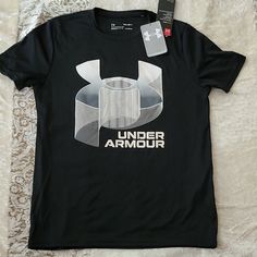 a black under armour t - shirt on a bed