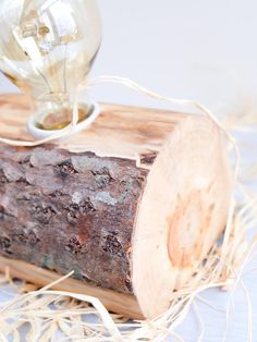 a light bulb sitting on top of a piece of wood