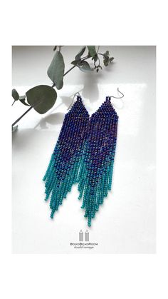 blue and green beaded earrings with long fringes hanging from the end of each ear