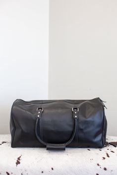 Expertly crafted from durable buffalo leather, our 22" Weekender Duffle Bag is a fine choice for your travels. It features a detachable shoulder strap for added convenience and an end zip pocket perfect for storing shoes. With three large open inside pockets, one zip pocket, and a luggage tag, this duffle offers plenty of space for your all your traveling needs. HF Henig Furs embossed logo on the front. Dye added Casual Leather Duffle Bag For On-the-go, Leather Duffle Bag With Zipper Pocket, Modern Duffle Bag With Leather Lining For On-the-go, Leather Duffle Bag With Zipper For On-the-go, Luxury Leather-lined Duffle Bag With Double Handle, How To Store Shoes, Chinchilla Fur, Leather Weekender, Fur Blanket