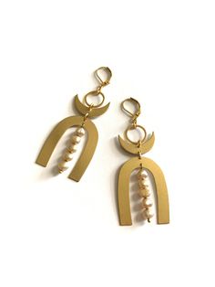 two pairs of gold earrings with pearls hanging from the bottom and on top of each other