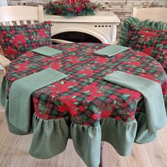 the table is covered with red and green plaid fabric, along with matching chair covers