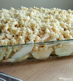 a casserole dish filled with food on top of a wooden table