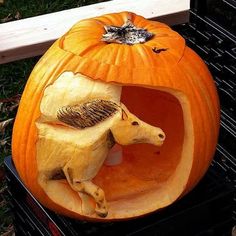 a carved pumpkin with an animal inside of it