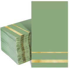 a stack of green cards with gold stripes