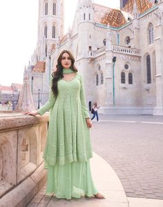 Mint green flared top with palazzo and dupatta Elegant Semi-stitched Green Sharara, Elegant Green Sharara For Eid, Elegant Green Sharara With Dabka, Elegant Green Sharara With Dabka Detailing, Green Georgette Kurta For Party, Green Maxi Length Kurta For Eid, Elegant Green Palazzo Set For Festive Occasions, Elegant Green Festive Palazzo Set, Green Bollywood Sharara For Party