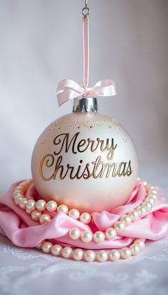 a christmas ornament hanging from a pink ribbon