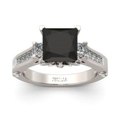 Sleek and streamlined, this sparkling black stone engagement ring is a unique look of love.This dazzling design showcases a black princess-cut stone flanked by smaller princess-cut stone. Additional round stones are set into the shank between intricate milgrain borders. This engagement ring will shoot straight to her heart.Carat Weight: 4.15 ctStone Size: 8*8 mmStone Type: Jeulia® StoneNumber of Stones: 1 Stone Color: Fancy BlackStone Shape: PrincessCarat Weight: 1.285 ctStone Size: 3*3,2.2,2,1.8,1.5,1.2 mmStone Type: Jeulia® StoneNumber of Stones: 18 Stone Color: Diamond WhiteStone Shape: Princess, RoundWeight: 3.63 gWidth: 9.42 mmHeight: 8.84 mmThickness: 2.64 mmMaterial: 925 SilverPlating Color: Silver Black Diamond Engagement Ring Vintage, Black Stone Ring Engagement, Argentium Silver Jewelry, Black Diamond Engagement Ring, White Diamond Rings Engagement, Fine Engagement Rings, Black Diamond Engagement, Sterling Silver Rings Set, Cz Rings Engagement