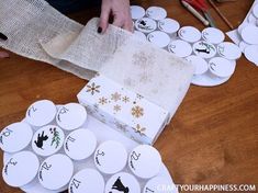 someone is wrapping up some christmas cards on the table