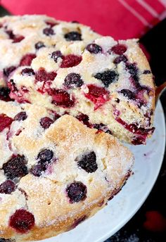 a cake with berries on it sitting on a plate