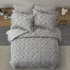 a bed that has some pillows on it