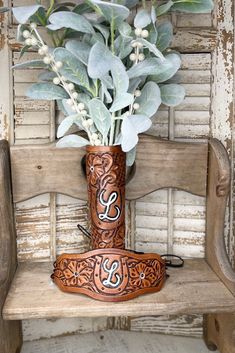 a vase filled with flowers sitting on top of a wooden bench