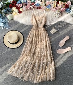 Step into the spotlight with this elegant gold sequin spaghetti strap maxi dress, perfect for making a dazzling entrance at any special event. The dress features a delicate nude tulle overlay adorned with shimmering gold sequins that catch the light with every movement, creating a radiant and glamorous effect. The slim spaghetti straps and V-neckline highlight your shoulders and collarbone, adding a touch of femininity and allure to the overall design.The flowing A-line silhouette flatters a var Gold V-neck Evening Dress For Summer, Glamorous Gold Tulle Dresses, Beige Maxi Dress For Summer Prom, Spring Sequin Prom Dress With Spaghetti Straps, Spring Prom Sequin Dress With Spaghetti Straps, Spring Sequin Spaghetti Strap Dress For Prom, Spring Spaghetti Straps Sequin Dress For Prom, Spaghetti Strap Maxi Dress For Wedding Guest And Prom, Party Season Sequin Dress With Spaghetti Straps