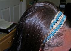 the back of a woman's head with a blue and white hair band