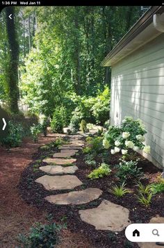 a stone path leading to a house in the woods