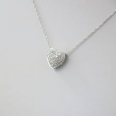 Single cut diamonds are pave set into this 14k white gold heart pendant. A Singapore white gold chain is the perfect addition to complete this necklace. Metal: 14K White Gold Necklace Length: 16 Inches Pendant Length x Width: 3/8 x 3/8 Inches Diamonds: .17 CTW, SI1 E-F For a greater selection of jewelry please visit our website at www.BlackMarketLLC.com If you have any questions about this product or if we can help you with any of our other products please contact us through Etsy or our website White Gold Heart Pendant Necklace With Pave Setting, Silver Heart-shaped Diamond Necklace With Pave Setting, White Gold Heart-shaped Necklace With Pave Setting, White Gold Heart Cut Necklace With Pave Setting, White Heart-shaped Necklaces With Single Cut Diamonds, White Heart Necklaces With Single Cut Diamonds, Sterling Silver Heart Necklace With Brilliant Cut For Wedding, White Diamond Necklace With Single-cut Heart Pendant, White Diamond Necklace With Single Cut Heart Pendant