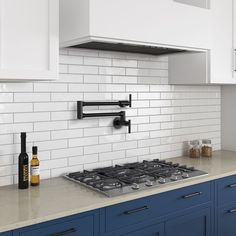 a stove top oven sitting inside of a kitchen next to blue cabinets and counter tops