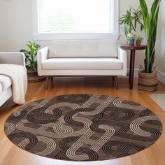 a living room filled with furniture and a large rug on top of a hard wood floor