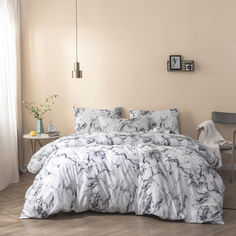 a bed with white and black marble print on it