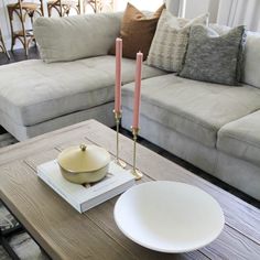 a coffee table with two candles on it